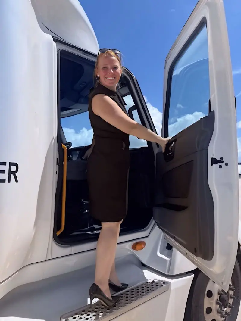 Ancora Training's Senior Director of Client Operations Kate Chauvin stands on truck runner.