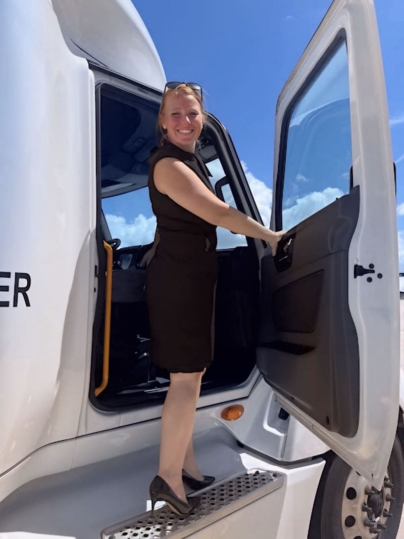 Ancora Training's Senior Director of Client Operations Kate Chauvin stands on truck runner.